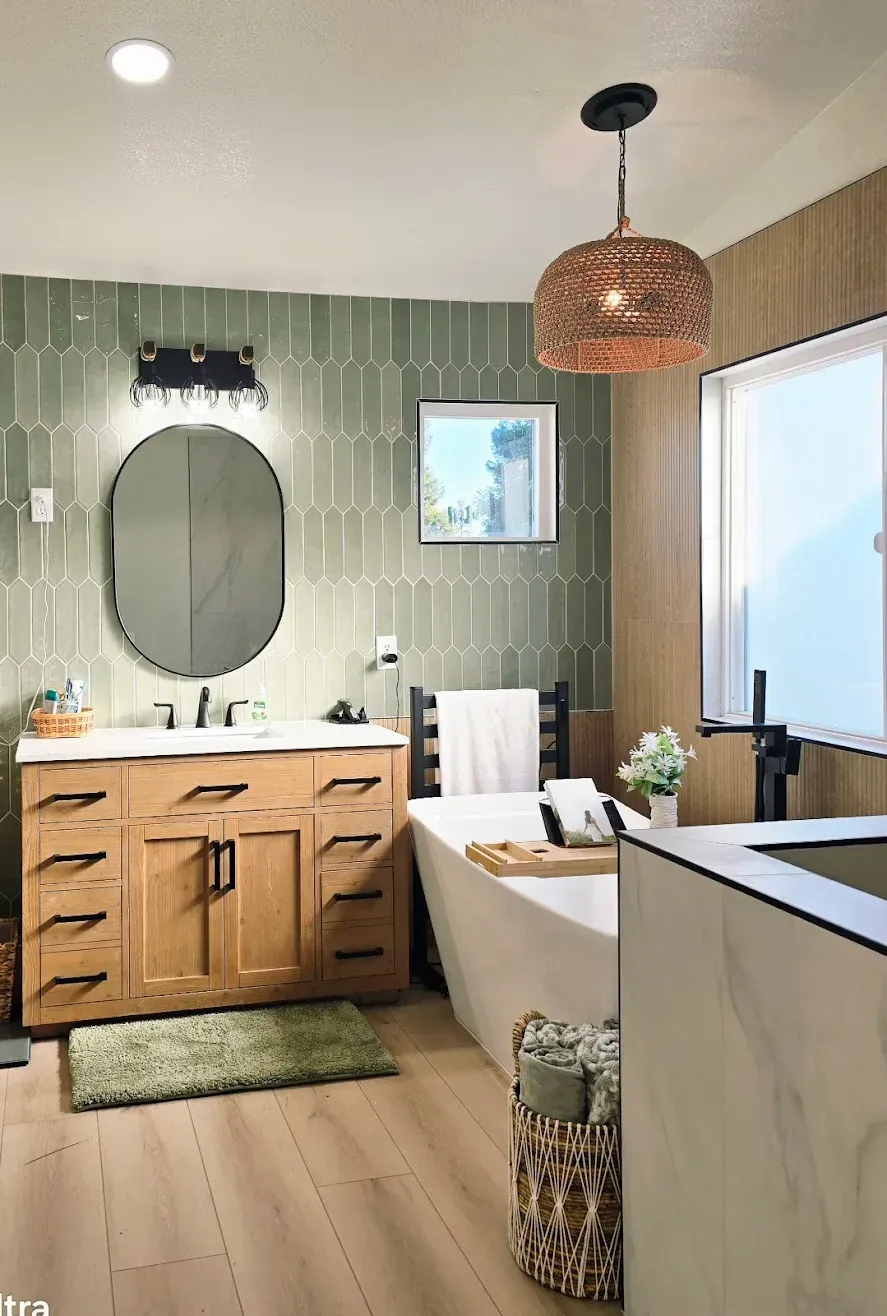 Modern bathroom with wood vanity, oval mirror, freestanding tub, and woven pendant light