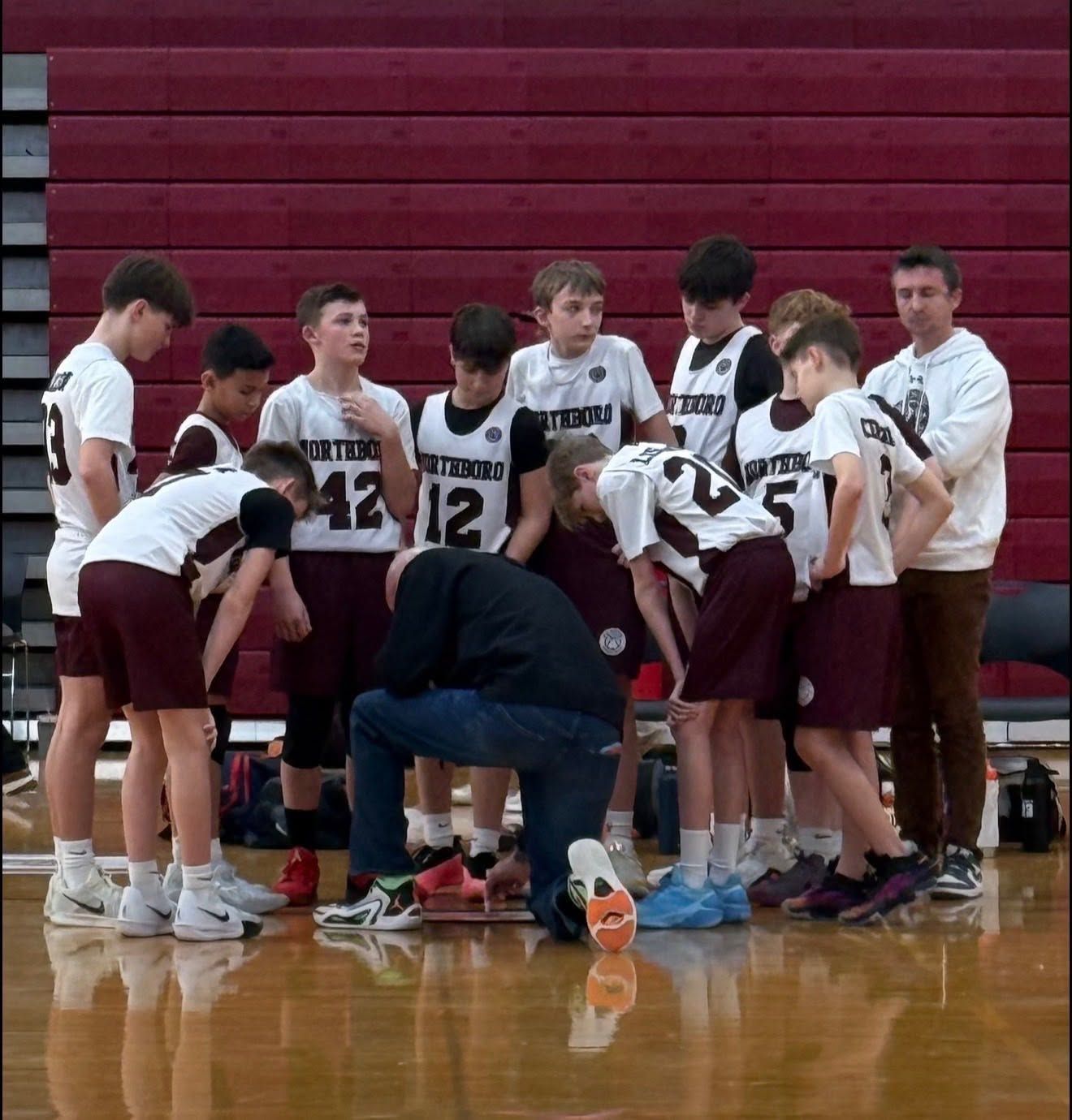 nyba team boys in a huddle