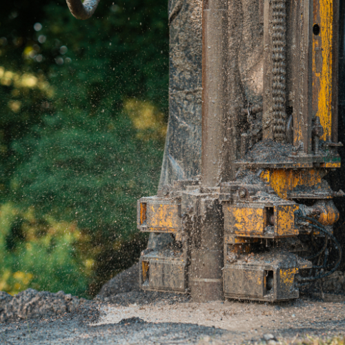 A close up of a machine that is drilling a hole in the ground.