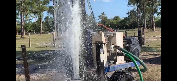 A water pump is being used to pump water from a well.