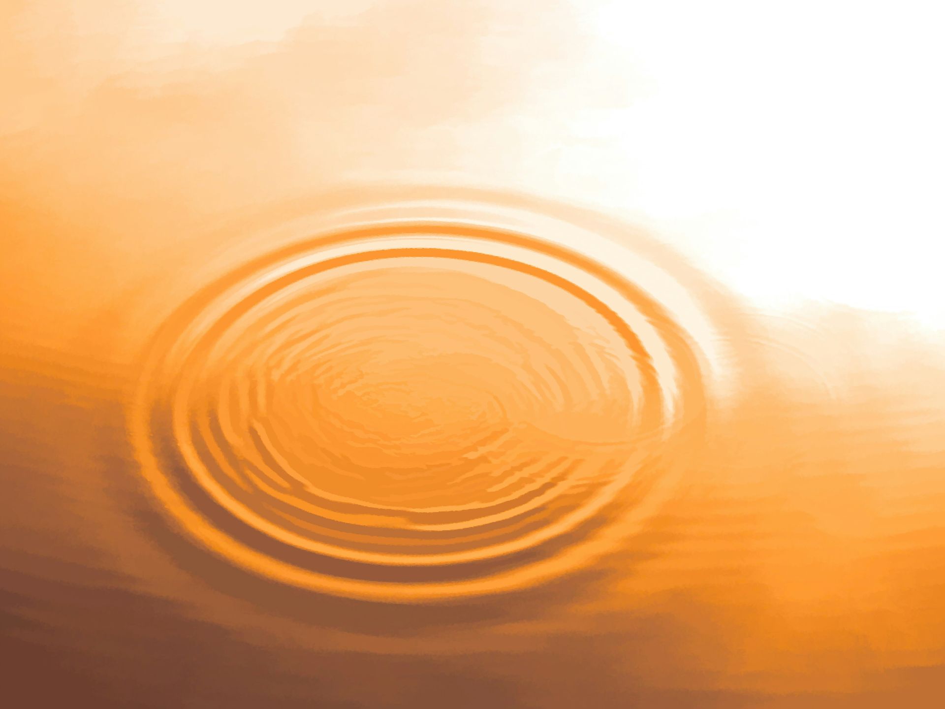 Des ondulations circulaires concentriques se propagent à la surface de l'eau orangée.