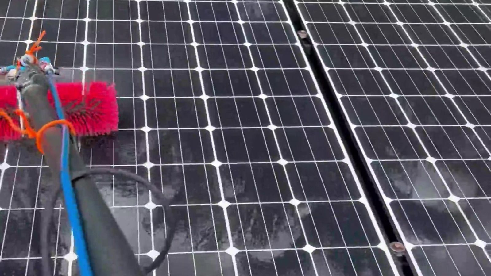 Rotating brush on a solar panel