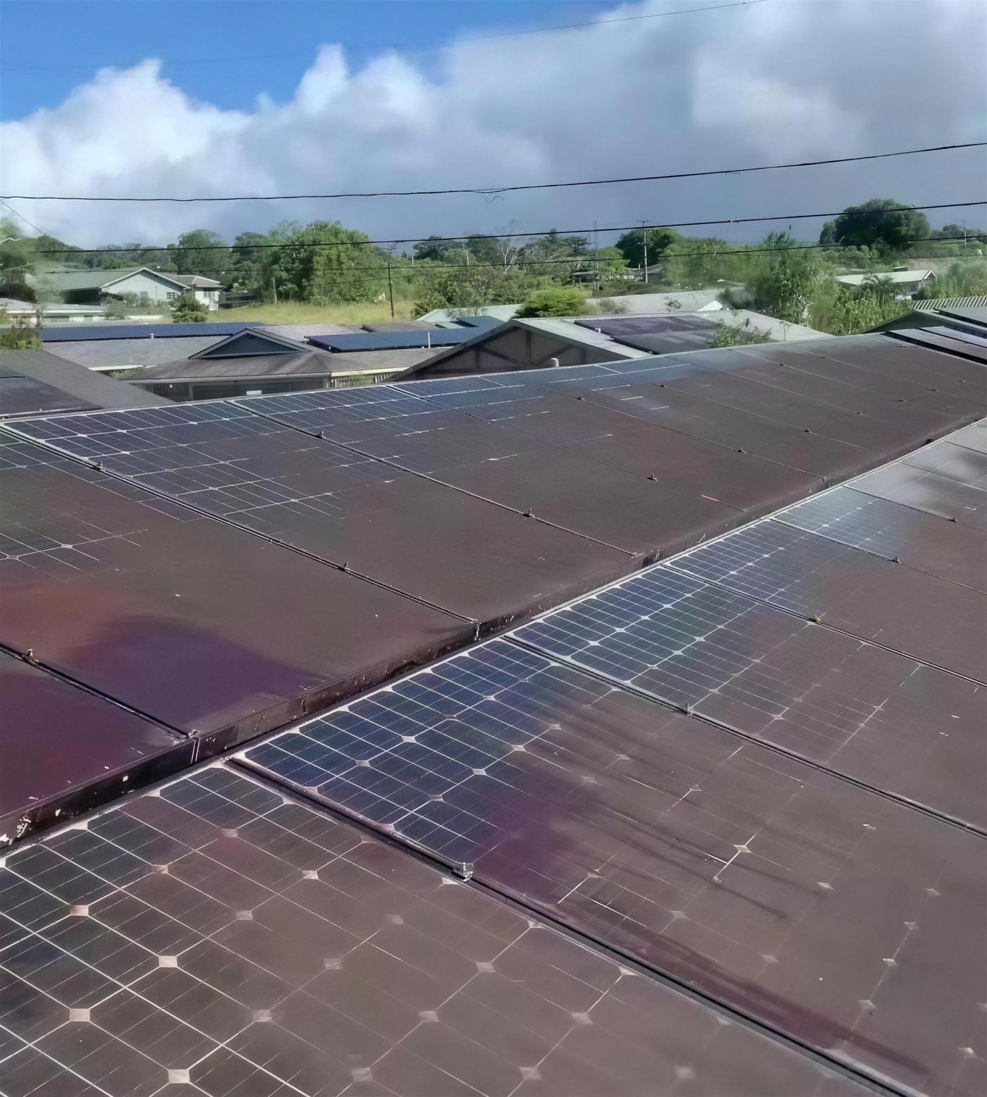 Red dirt and black mold baked onto a residential solar array before cleaning