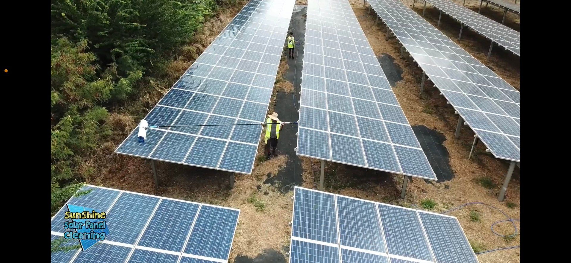 Aerial view of solar farm rows on Oahu with the crew between them