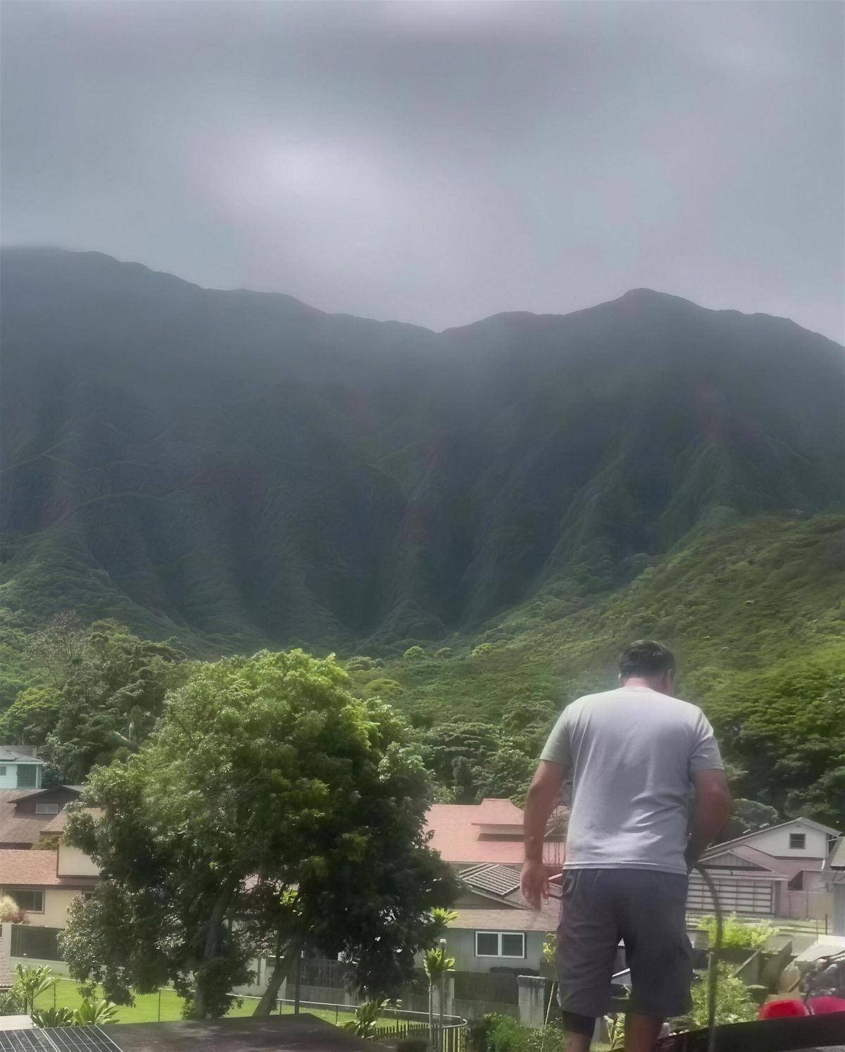 A Sunshine tech on a Kaneohe roof under the Koolau range