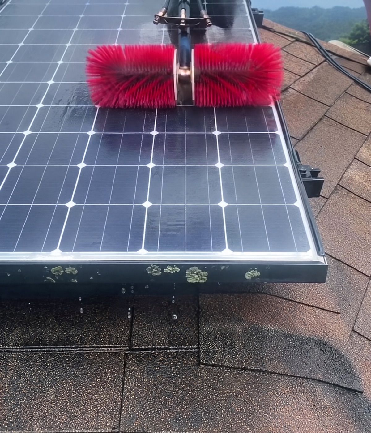 Rotating brush cleaning the same solar panels