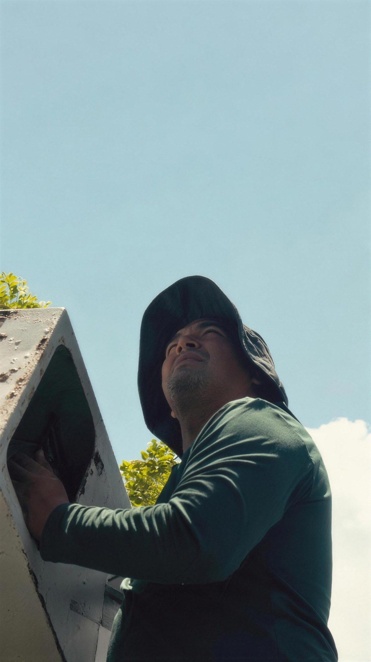 Angel clearing a roof gutter by hand