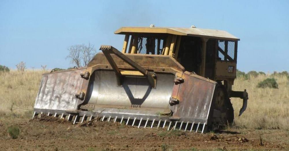 A Bulldozer is Sitting in the Middle of a Field — Oakleigh Earthmoving in Chinchilla, QLD
