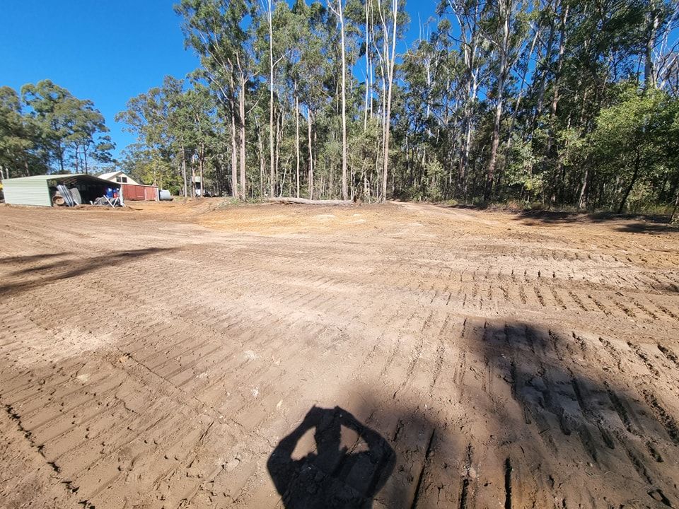 Cleared Dirt Lot With Tire Tracks, Trees Along the Edge, and a Small Shed — Oakleigh Earthmoving in Cotswold Hills, QLD