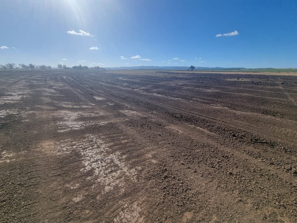 An Aerial View of a Muddy Field With a Blue Sky in the Background — Oakleigh Earthmoving in Warwick, QLD