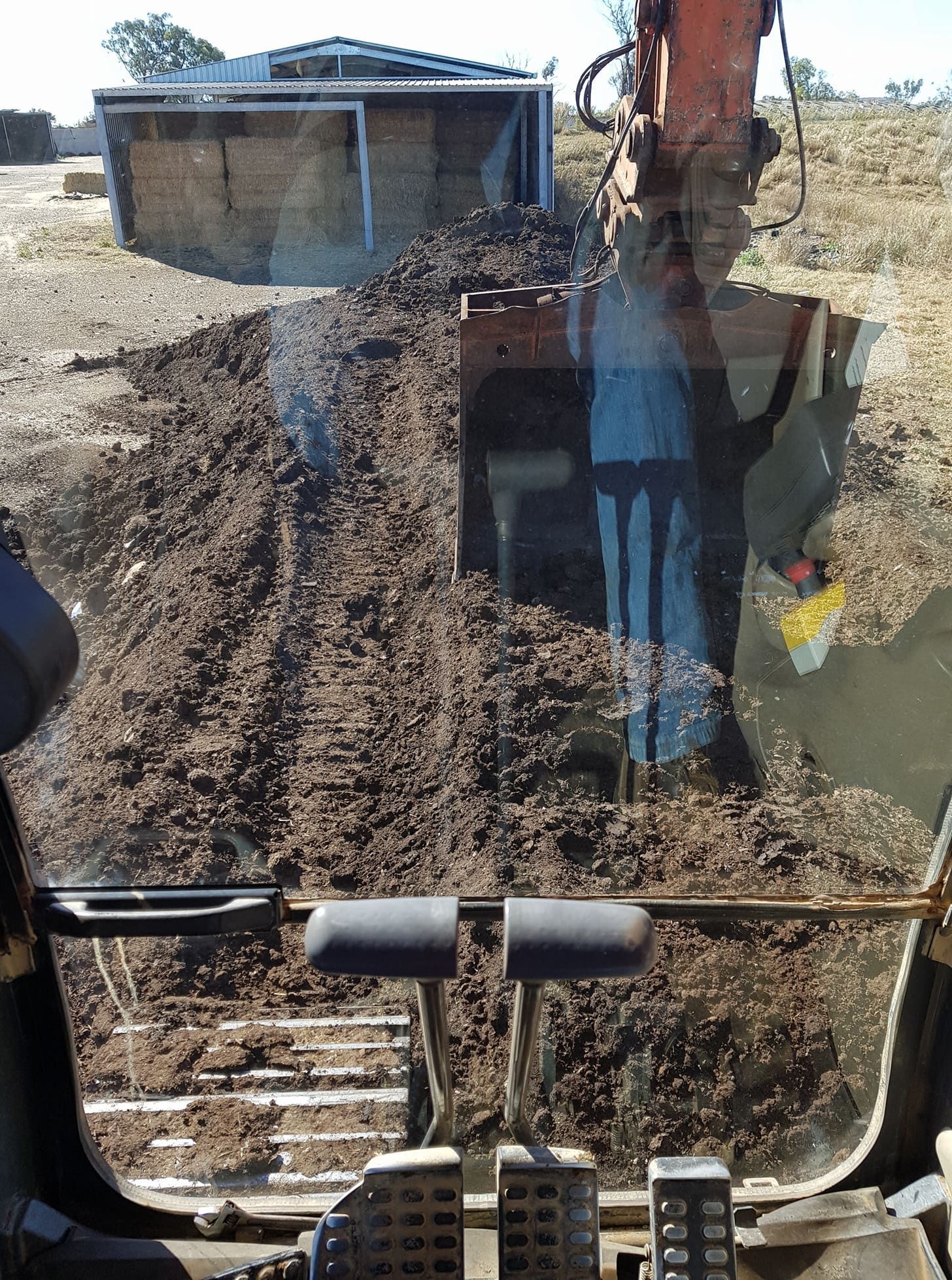 Excavator Digs a Trench Beside a Small Building at a Construction Site — Oakleigh Earthmoving in Kingaroy, QLD