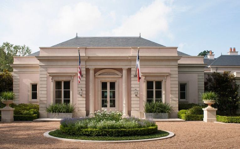 a large house with two american flags in front of it