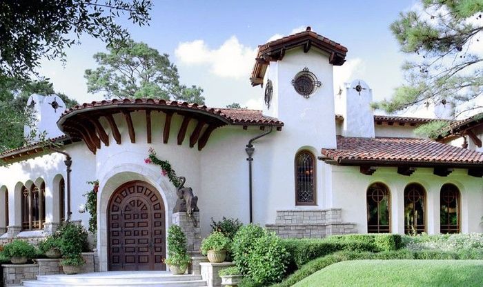 a large white house with a red tile roof