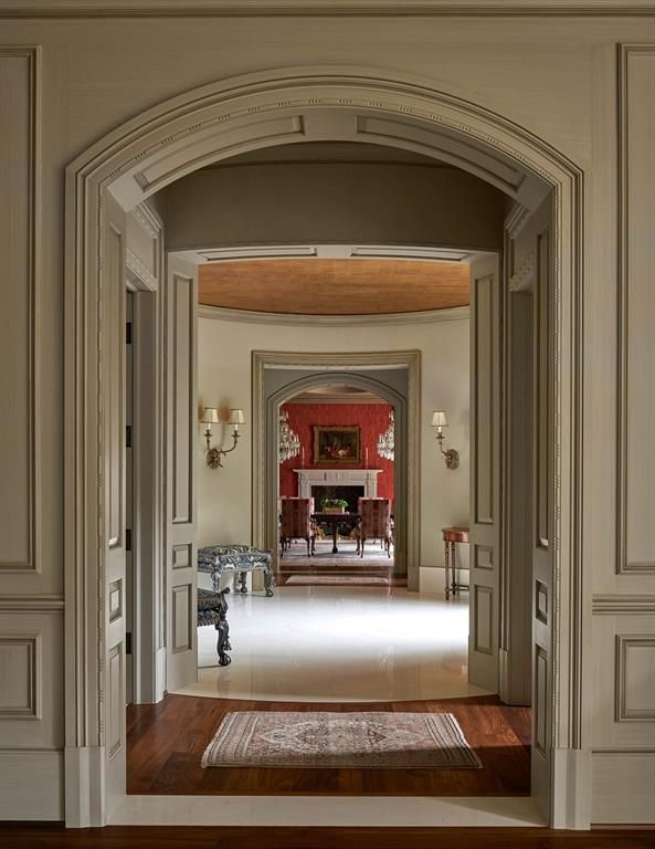 a hallway with a fireplace in the middle of it