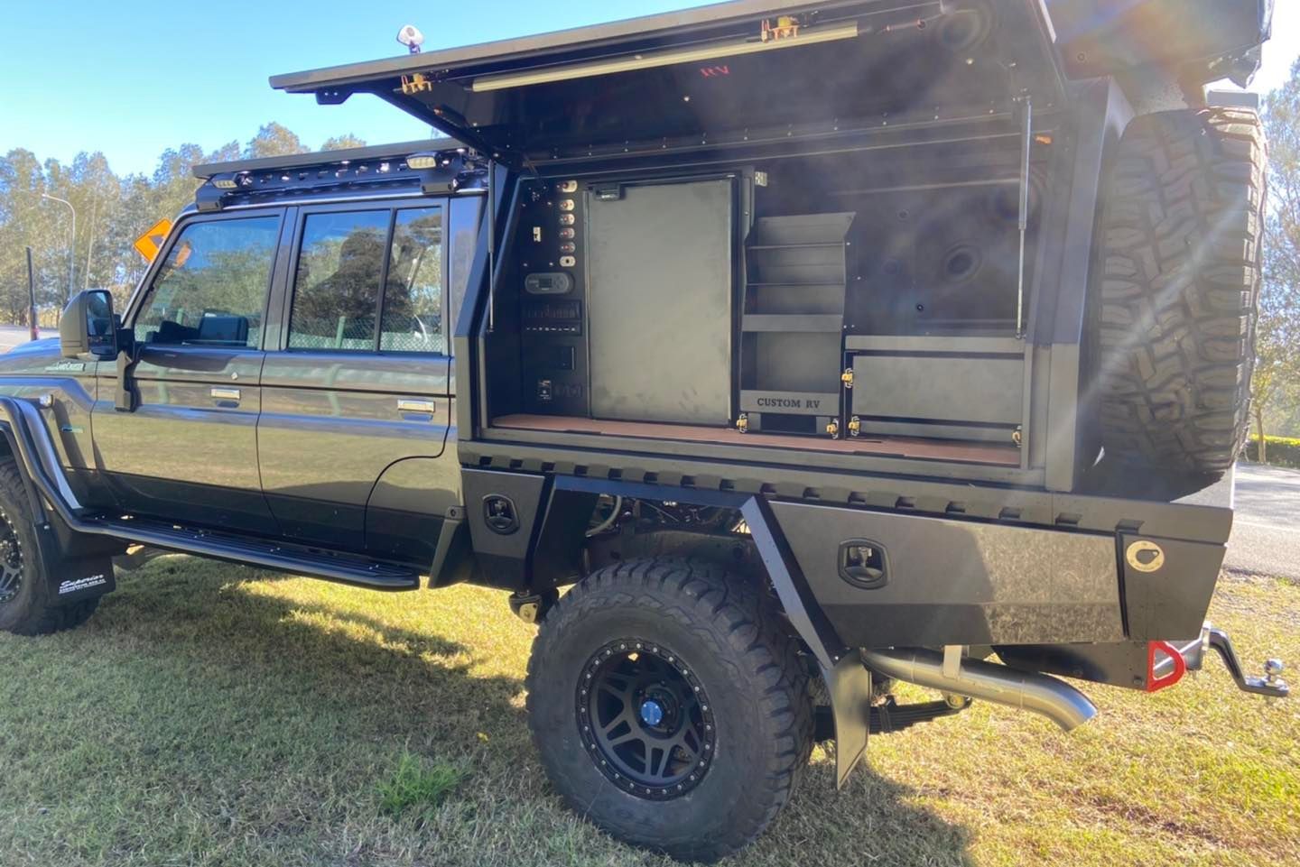 Black 4x4 Truck With a Customized Utility Bed. Open Side Shows Shelving and Storage — Custom RV Creations in Sumner, QLD