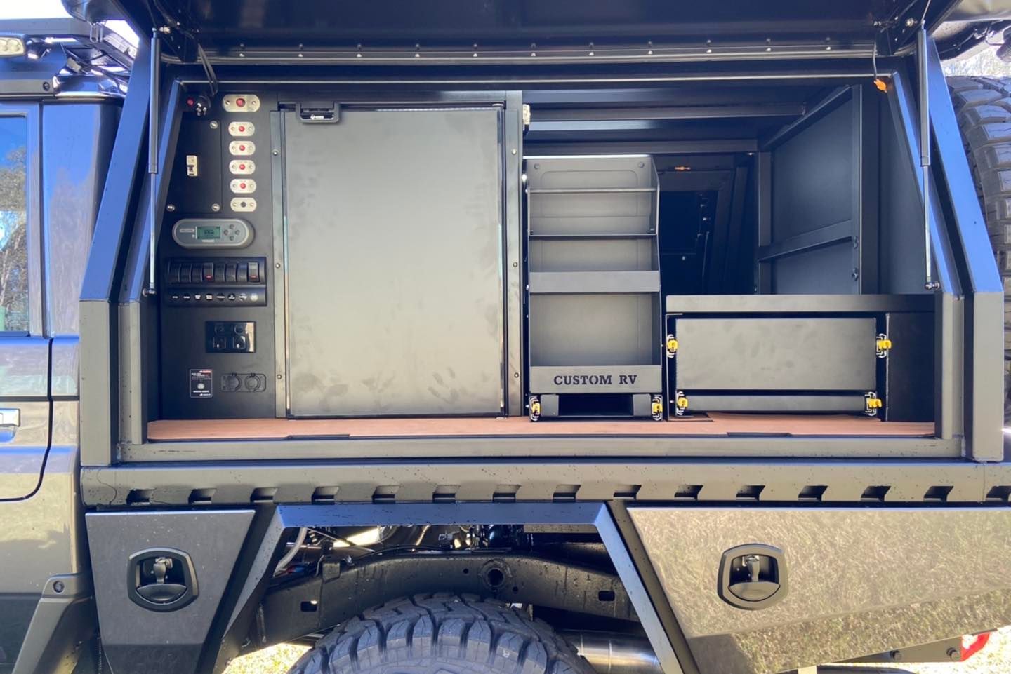 Dark Truck Bed With Built-in Storage, Fridge, and Shelving, All in Shades of Black — Custom RV Creations in Ipswich, QLD