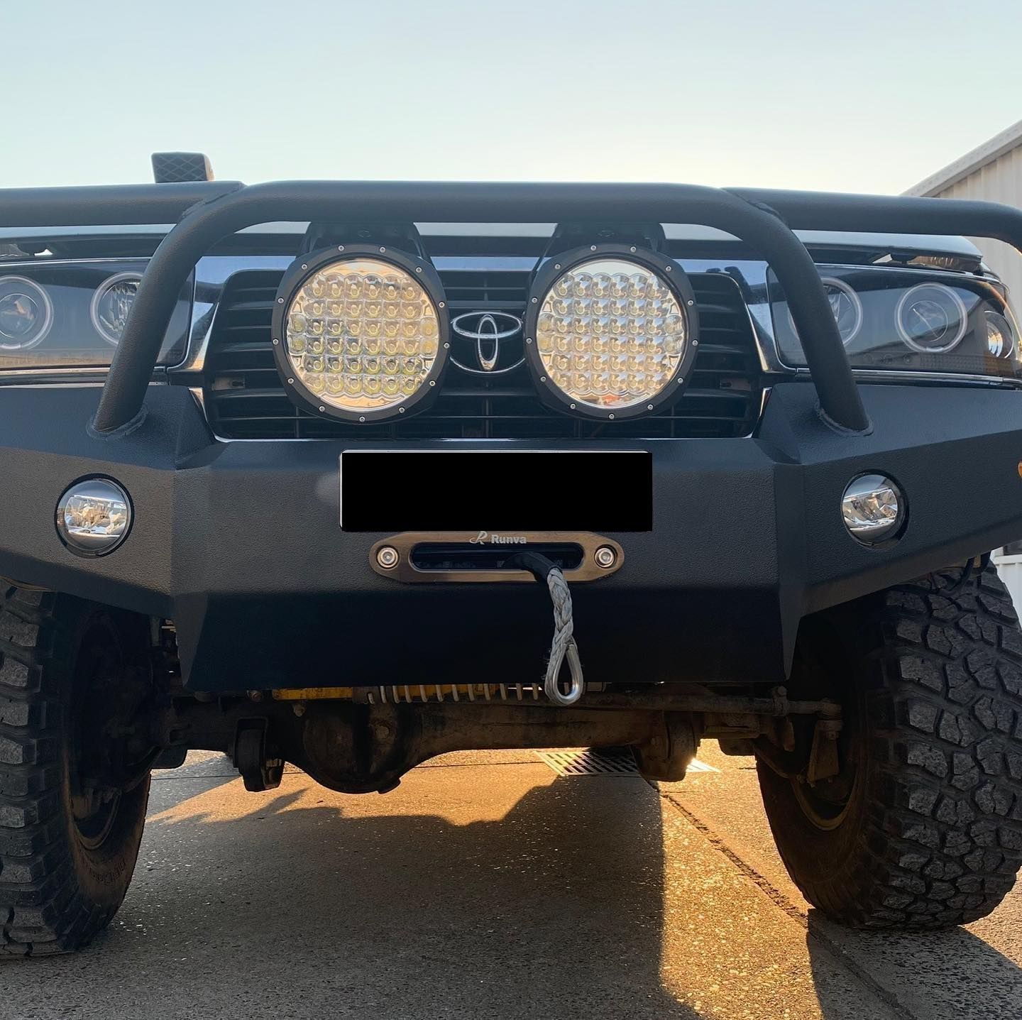 Black Off-road Truck With Large Round Headlights and a Winch — Custom RV Creations in Sumner, QLD