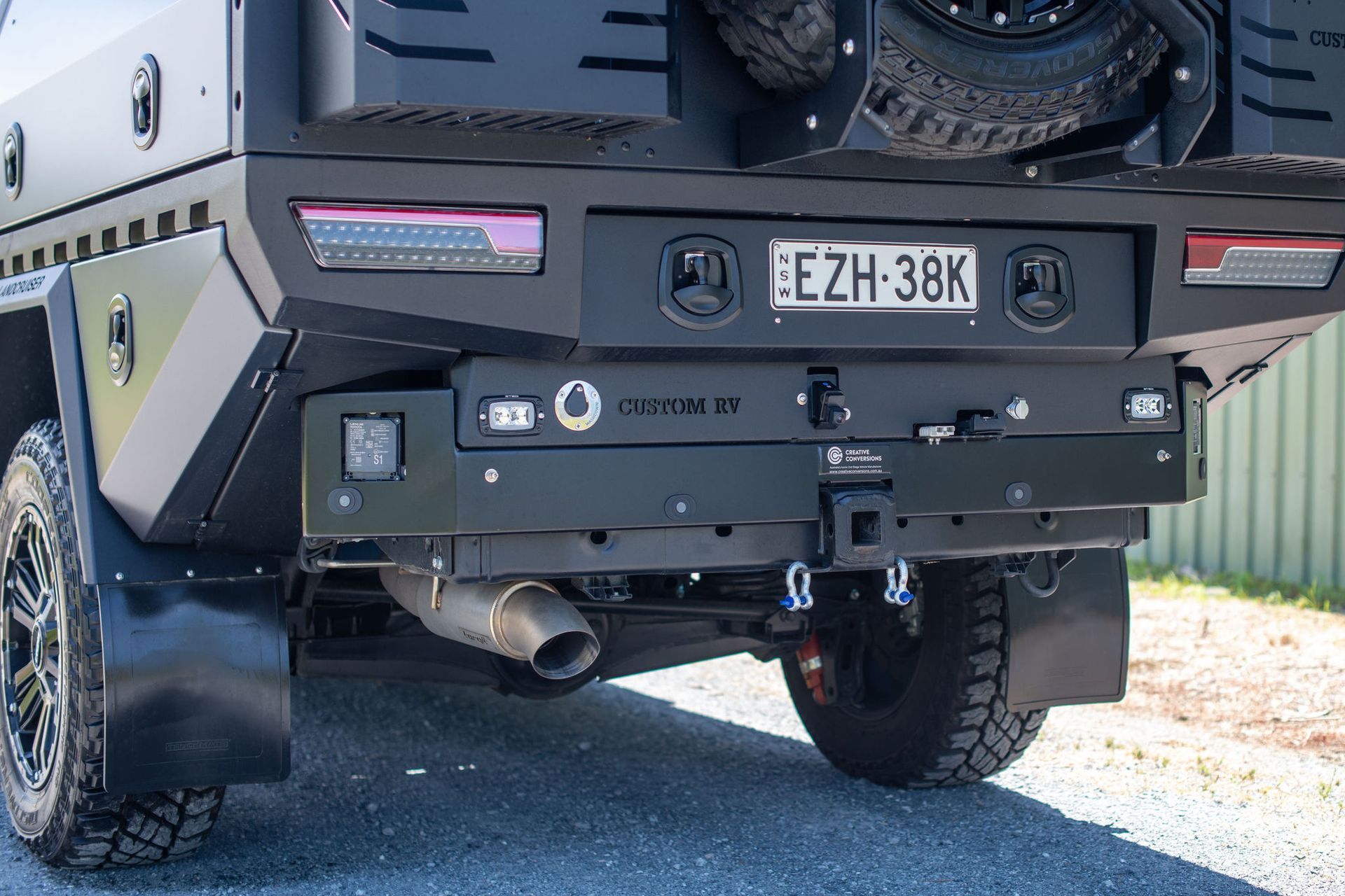 Black Truck Rear With Bumper, License Plate, Lights, and Exhaust Pipe — Custom RV Creations in Sumner, QLD