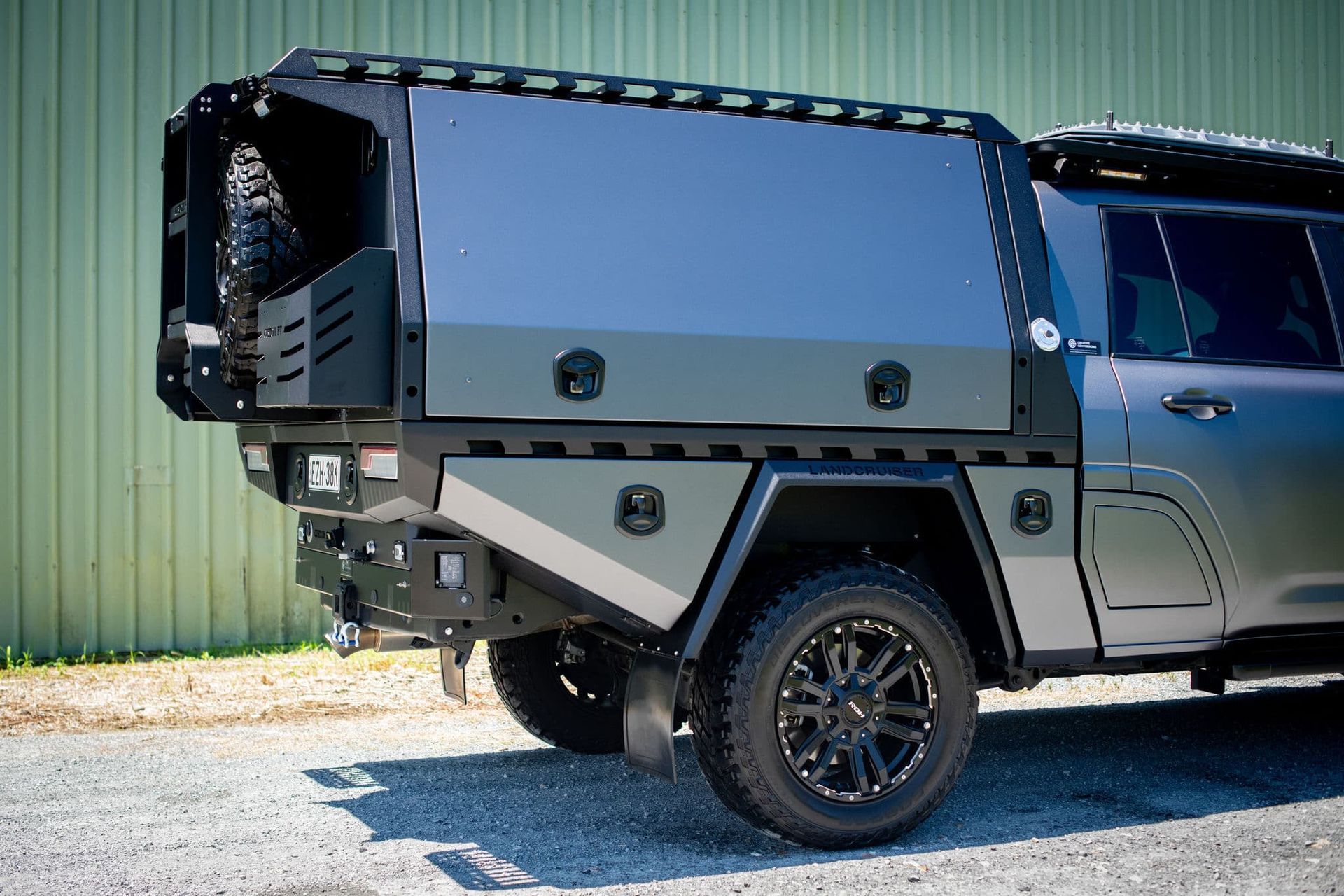 A Custom Utility Canopy Mounted on a Grey SUV, With Black Wheels and Accessories — Custom RV Creations in Gold Coast, QLD