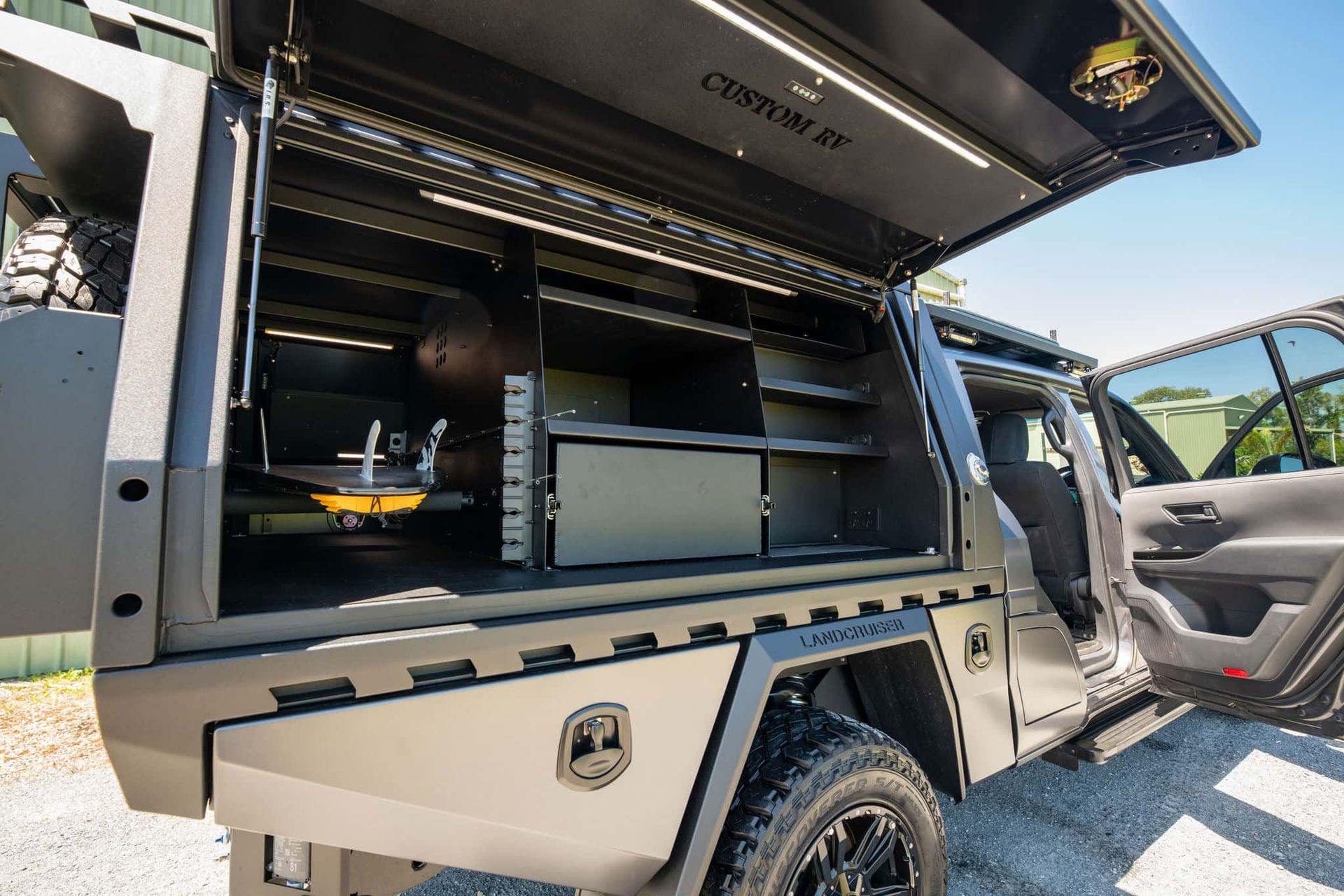 Black Custom Truck Bed With Open Compartments, Shelves, and Interior Lighting — Custom RV Creations in Sumner, QLD