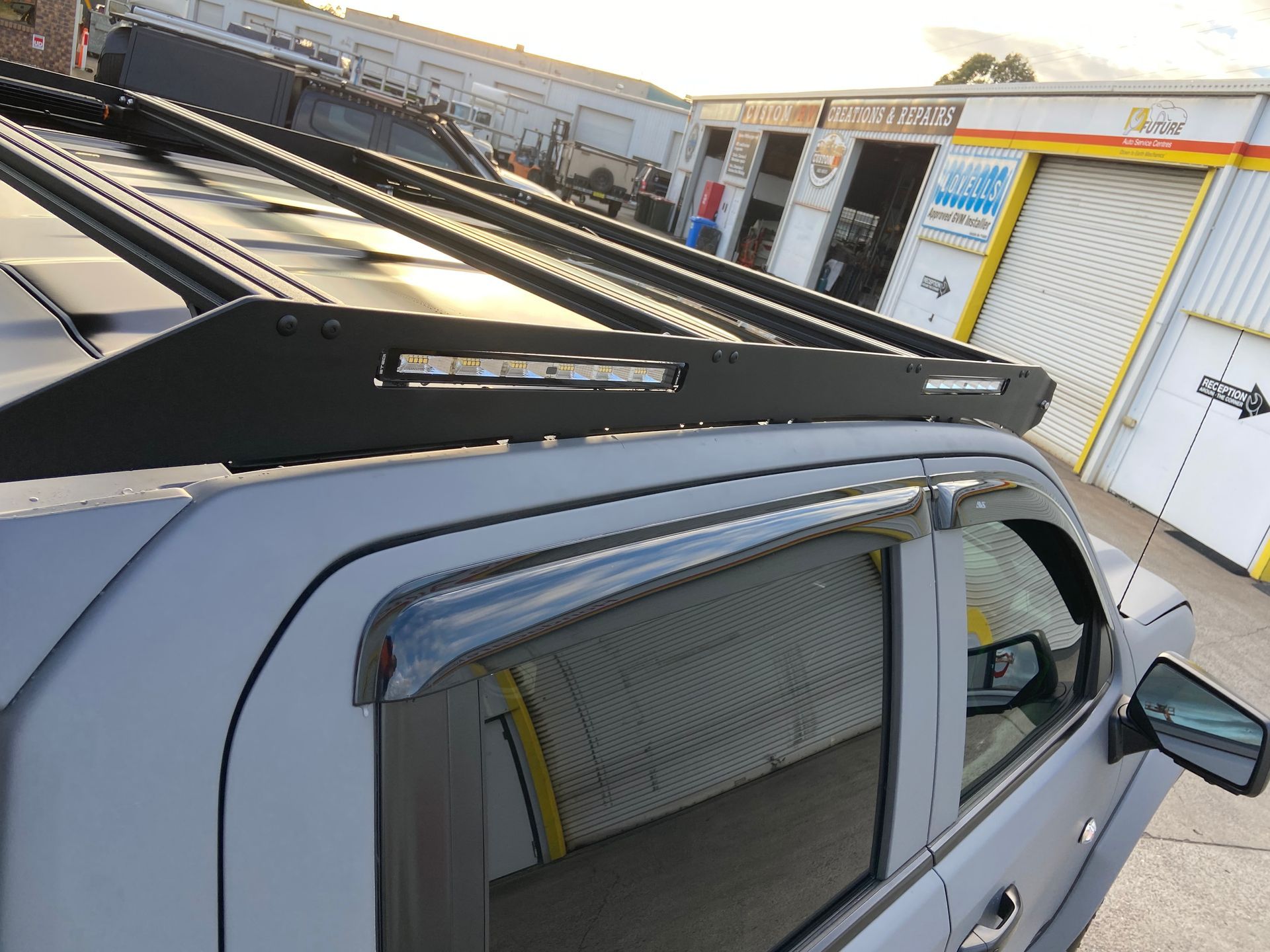 Black Roof Rack With LED Light Bar on a Gray Pickup Truck — Custom RV Creations in Sumner, QLD