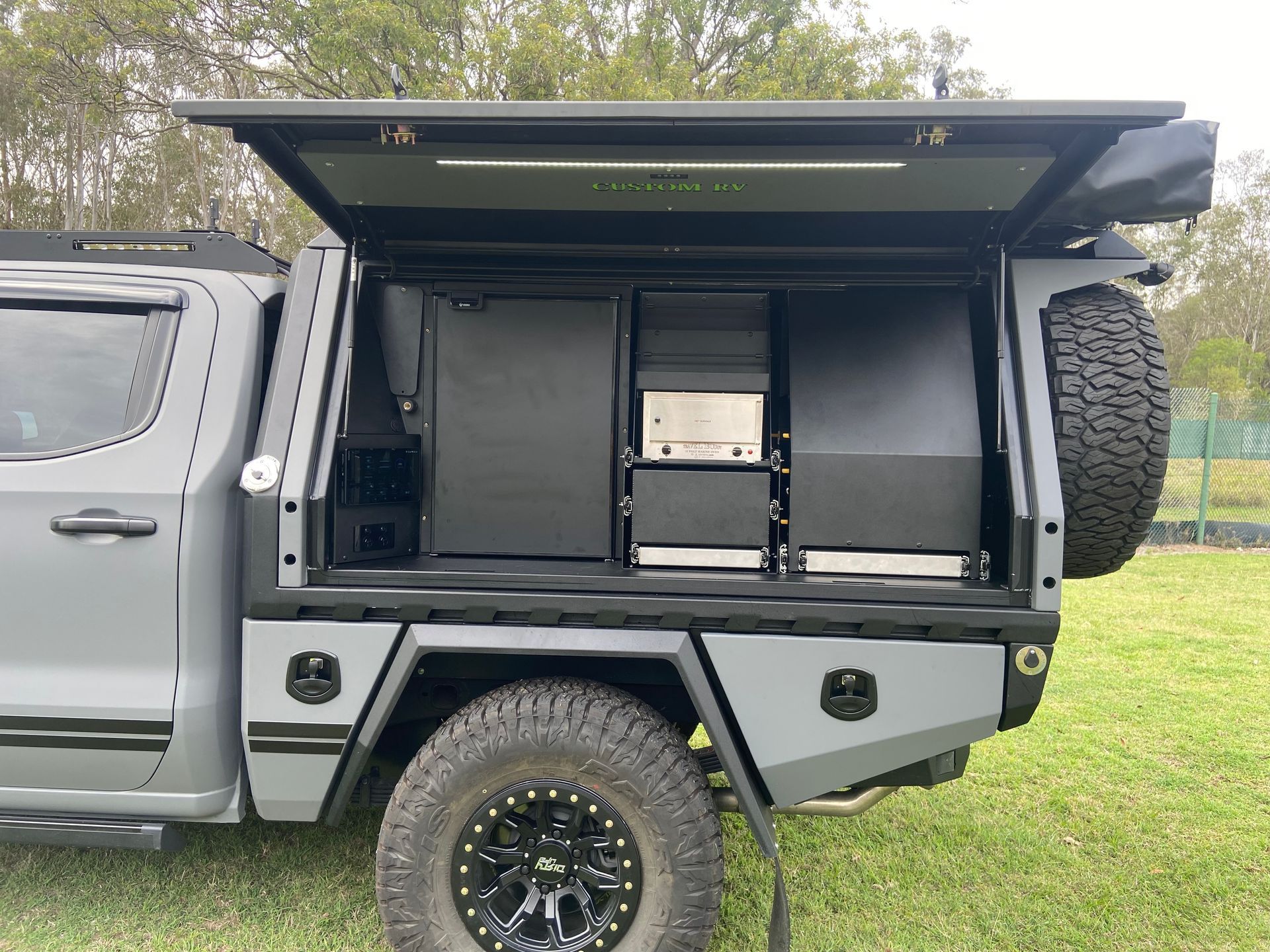 Pickup Truck With an Open Camper Shell, Featuring a Fridge, Drawers, and Spare Tire — Custom RV Creations in Sumner, QLD