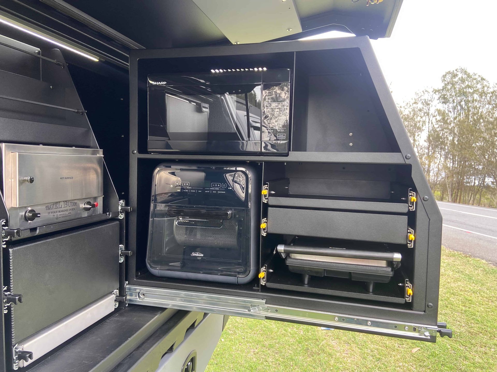 Black Camper Unit With Built-in Microwave, Toaster, Air Fryer, and Grill, Parked on Roadside — Custom RV Creations in Sumner Park, QLD