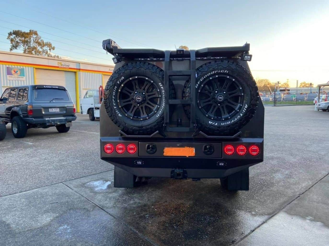 A Black Vehicle is Parked in a Parking Lot — Custom RV Creations in Sumner, QLD
