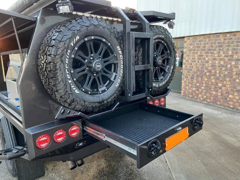 A Vehicle With a Tire Rack Attached to the Back of It — Custom RV Creations in Sumner, QLD
