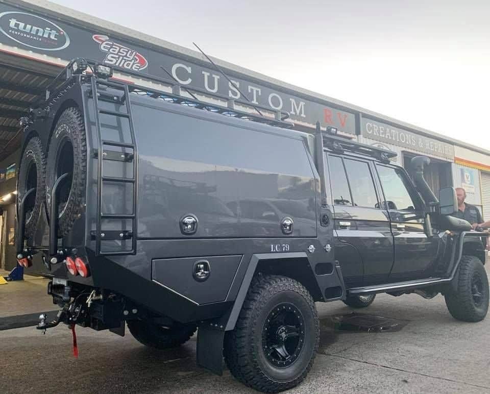 A Black Vehicle is Parked in Front of a Building — Custom RV Creations in Sumner, QLD