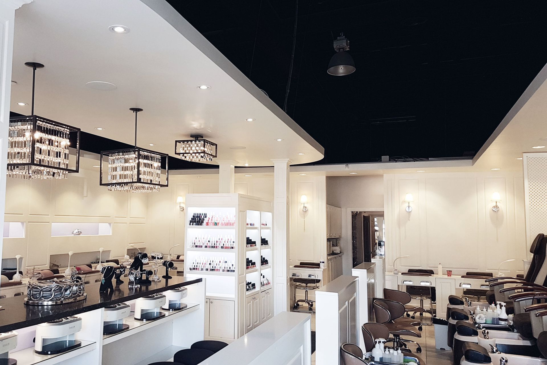 A nail salon with a lot of chairs and tables.