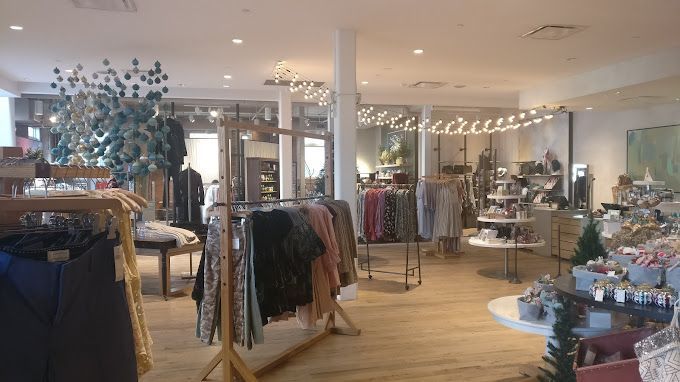 A store filled with clothes and a christmas tree.