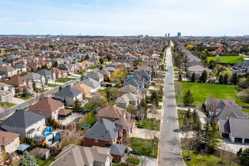 An aerial view of a residential area with lots of houses and trees.