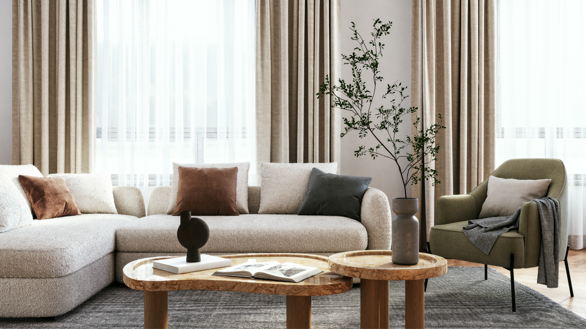 Interior photo of a living room with modern neutral furniture and drapes.