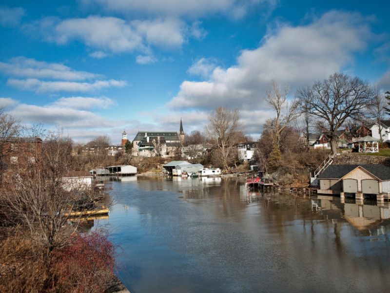 A river runs through a small town with a church in the background.