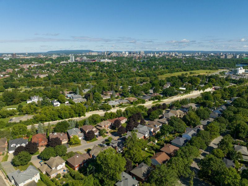 An aerial view of a residential area with a city in the background.