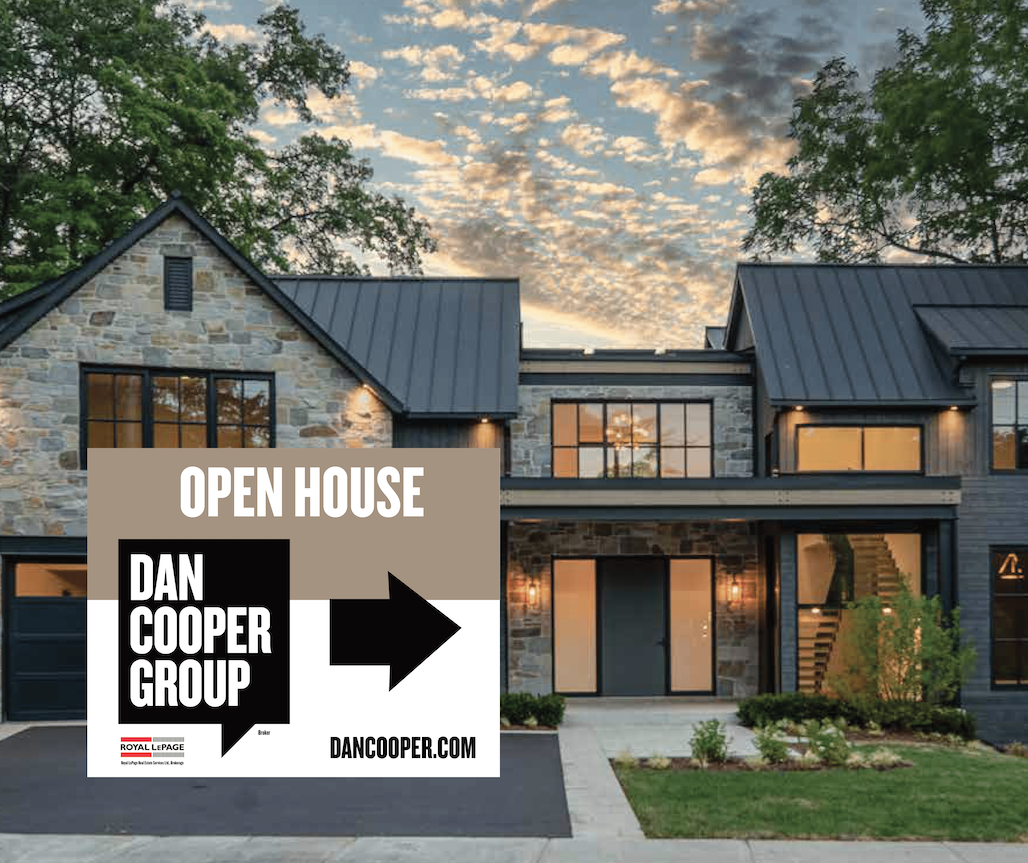 A large house with an open house sign in front of it