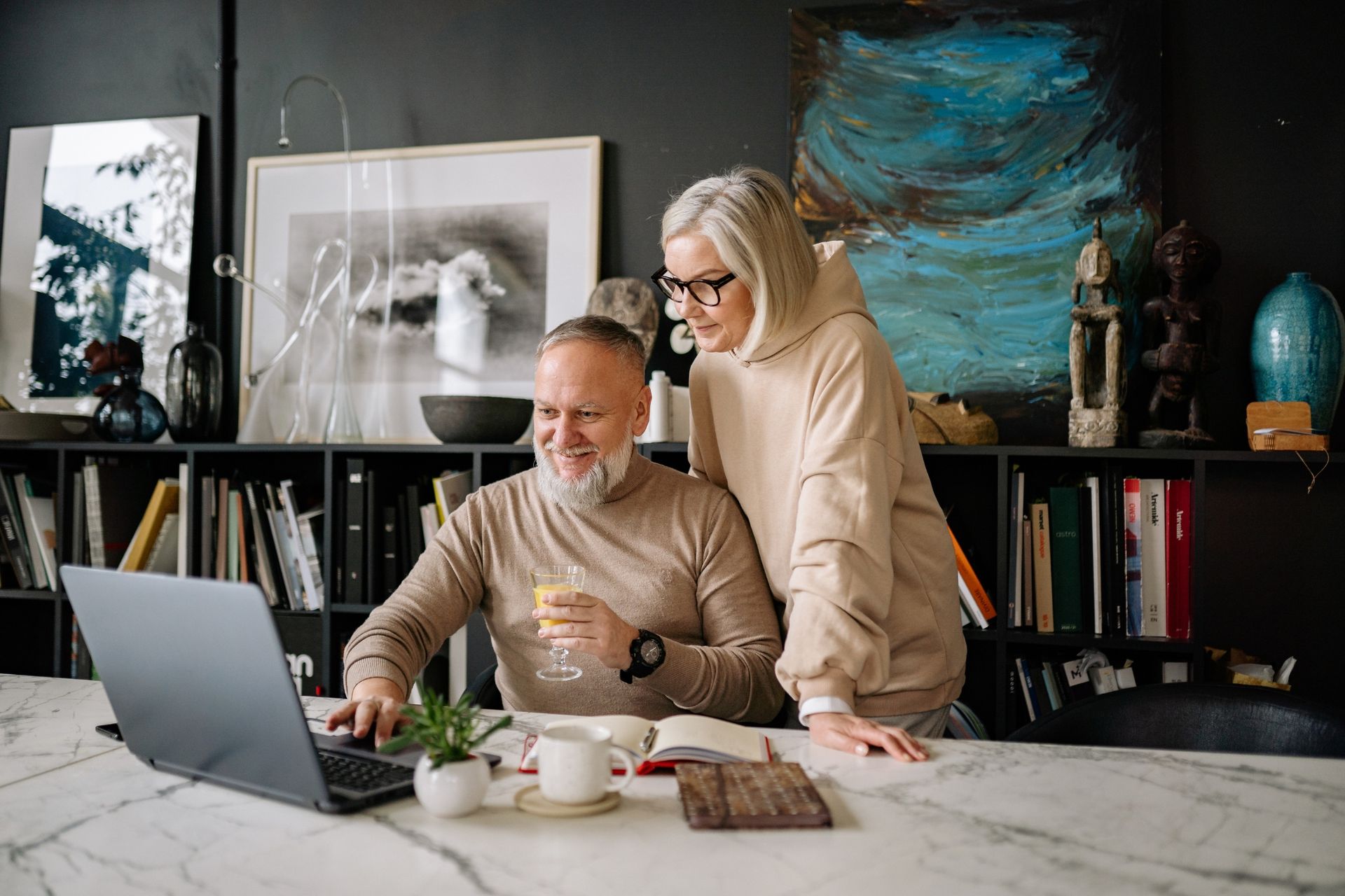 Photo of an older couple looking at a laptop.
