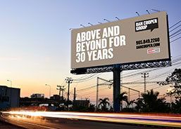 A billboard on the side of a highway that reads: Above and beyond for 30 years ''