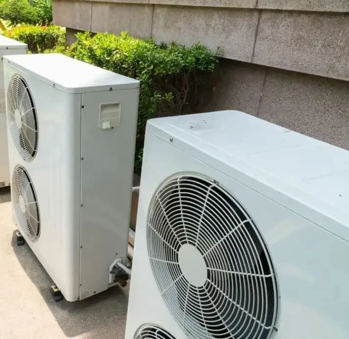 Two White Air Conditioners Exhaust — Gordon's Air Conditioning & Refrigeration Services in Caloundra, QLD