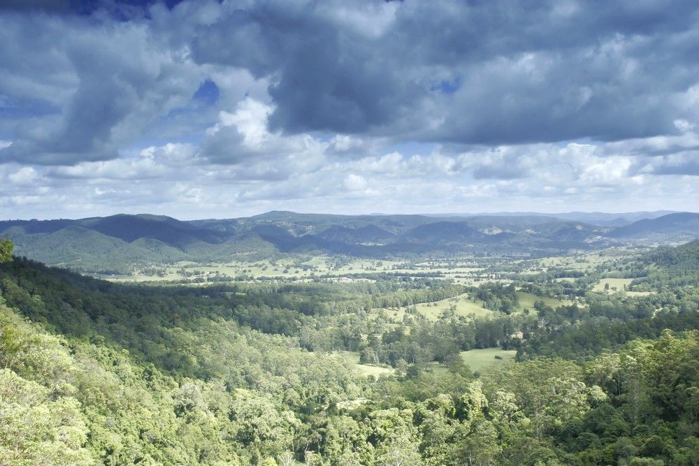 Green Valley with Rolling Hills Under a Cloudy Sky — Gordon's Air Conditioning & Refrigeration Services in Mapleton, QLD