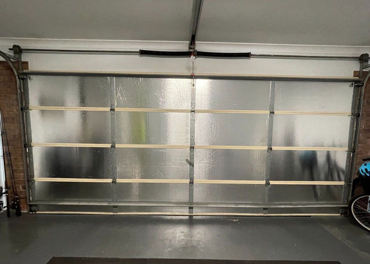 Garage door, frosted glass panels, wood accents, closed, interior view.