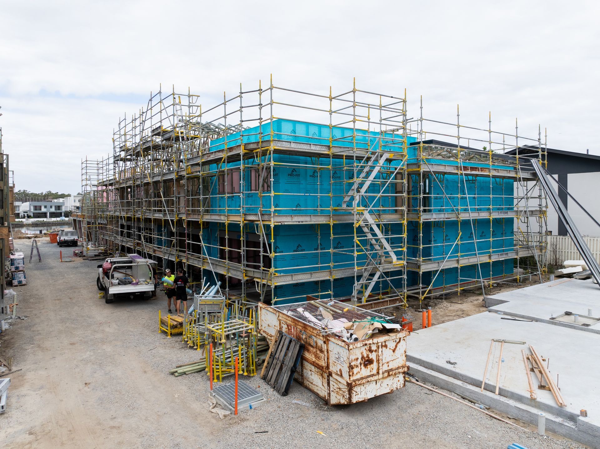 Building under construction, surrounded by scaffolding. Teal colored walls.