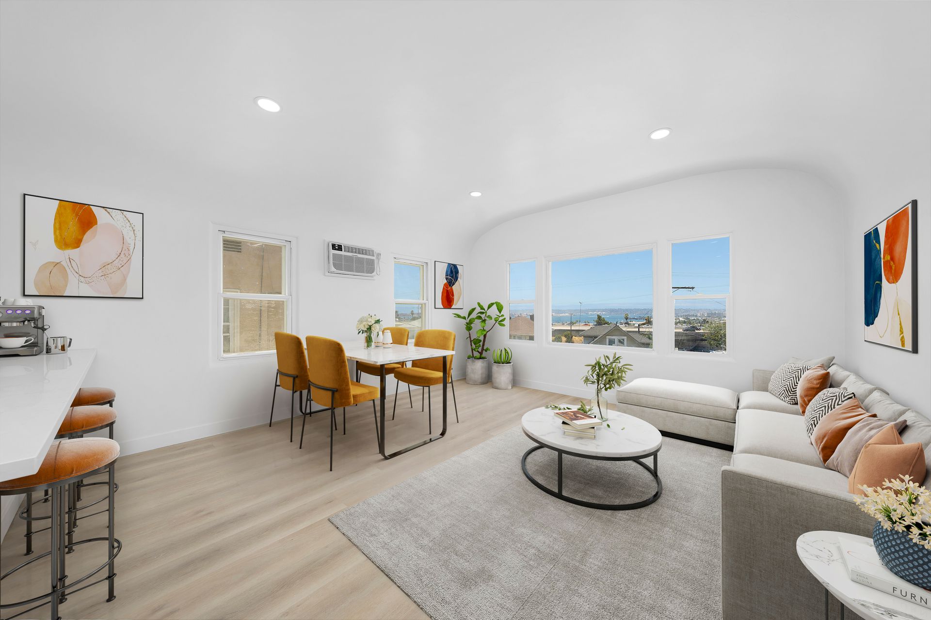 A living room with a couch , table and chairs