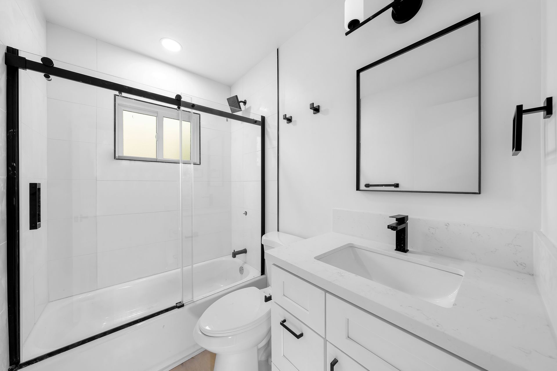 A bathroom with a toilet , sink , and shower.