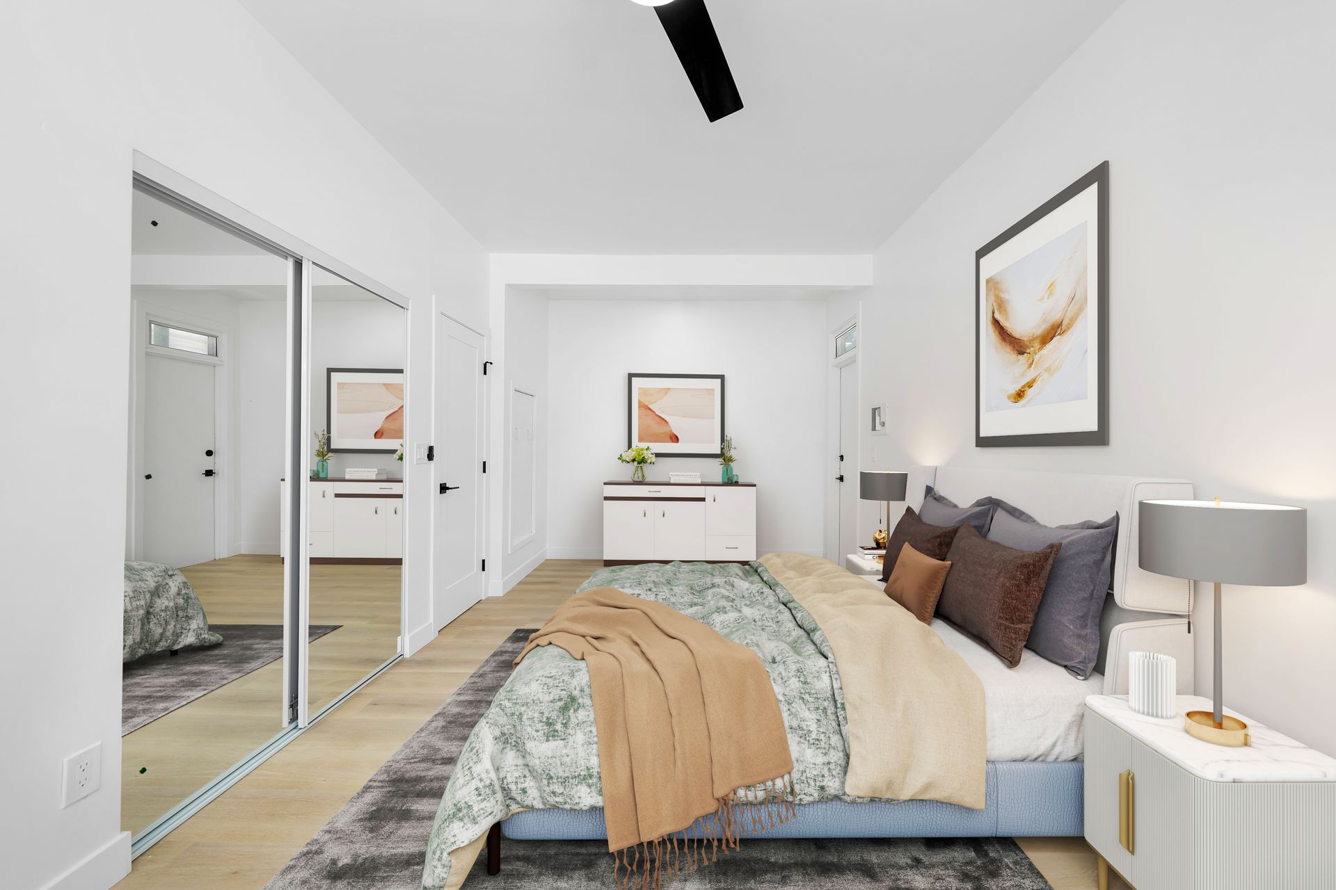 A bedroom with a large bed and a ceiling fan.