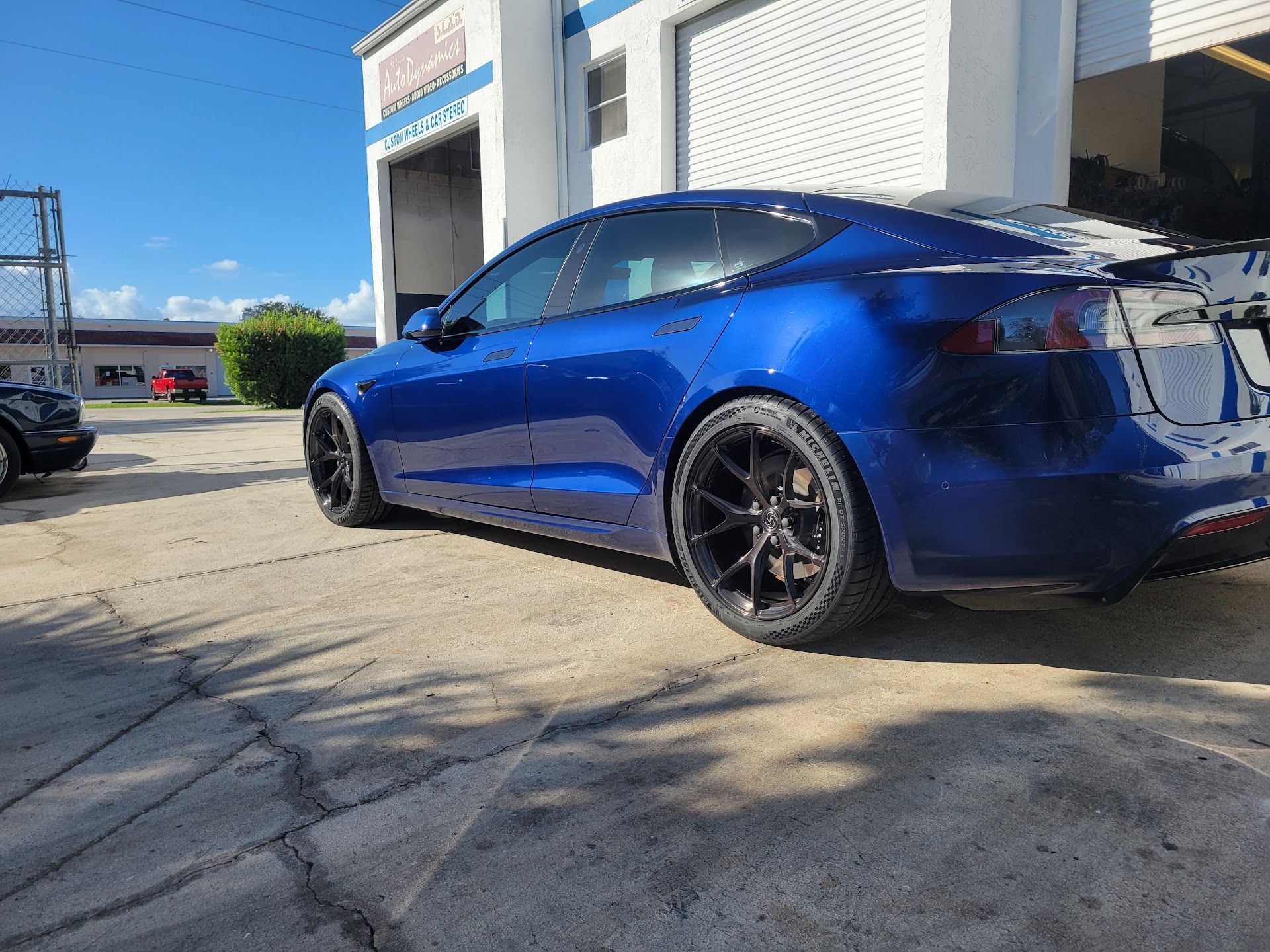 Blue Tesla parked outside a building | St. Lucie Auto Dynamics