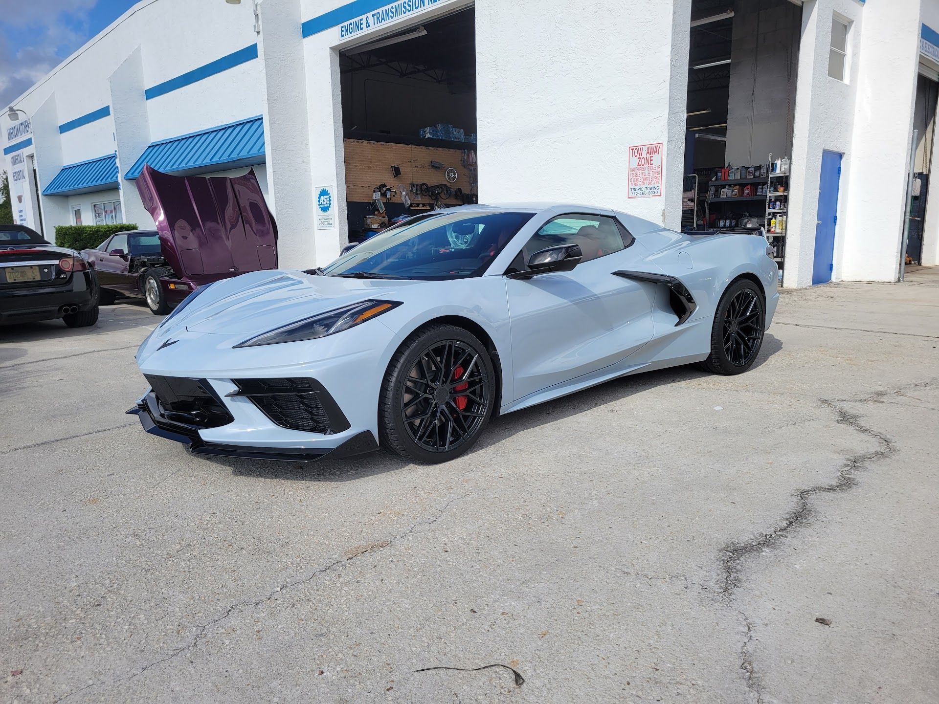 Light blue sports car parked in front of the auto shop | St. Lucie Auto Dynamics