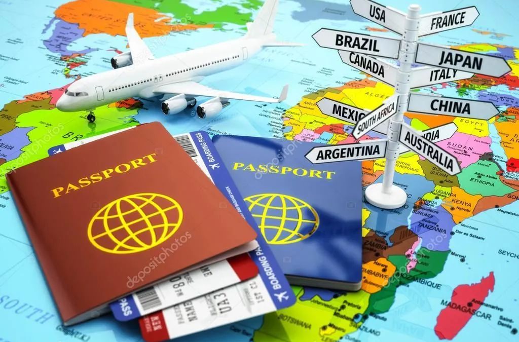 A passport , airline tickets , and an airplane on a map of the world.