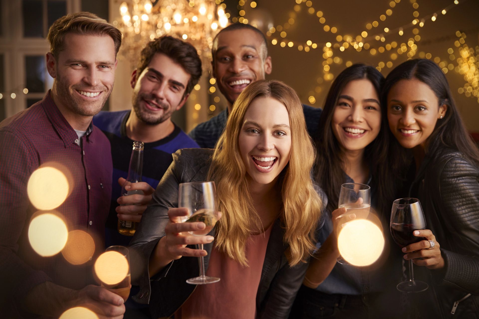 A group of people are toasting with champagne glasses at a party.
